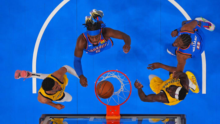 Jun 8, 2025; Oklahoma City, Oklahoma, USA;  Indiana Pacers guard Tyrese Haliburton (left) and forward Pascal Siakam (right) watch the ball go into the basket against Oklahoma City Thunder guard Luguentz Dort (5) and forward Jalen Williams (8) during the first half during game two of the 2025 NBA Finals at Paycom Center. Mandatory Credit: Kyle Terada-Imagn Images