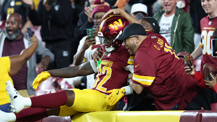 Washington Commanders running back Jacory Croskey-Merritt celebrates with fans in the stands after scoring a touchdown. Washington Commanders running back Jacory Croskey-Merritt celebrates with fans in the stands after scoring a touchdown.