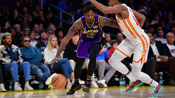 Jan 3, 2025; Los Angeles, California, USA; Los Angeles Lakers forward Dorian Finney-Smith (17) moves the ball against Atlanta Hawks forward De'Andre Hunter (12) during the second half at Crypto.com Arena. Mandatory Credit: Gary A. Vasquez-Imagn Images