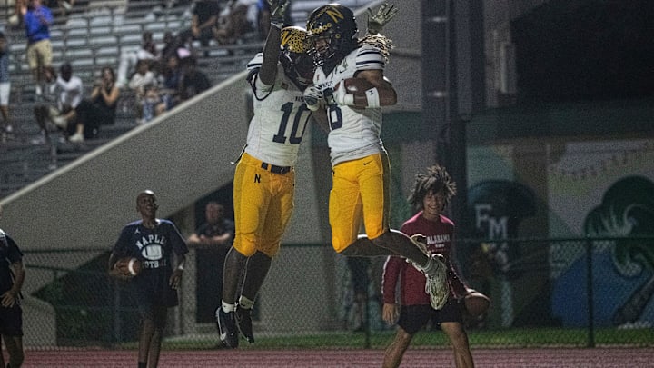 Caleb Dume, left, and James Lachance, of the Naples football team celebrate a touchdown caught by Lachance during a game at Fort Myers High School on Friday, Oct. 4, 2024.