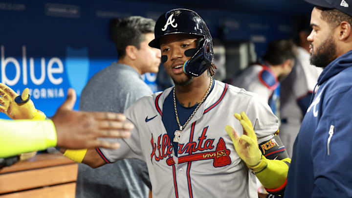 May 3, 2024; Los Angeles, California, USA;  Atlanta Braves outfielder Ronald Acuna Jr. (13) is greeted by teammates after hitting a home run in the eighth inning against the Los Angeles Dodgers at Dodger Stadium.