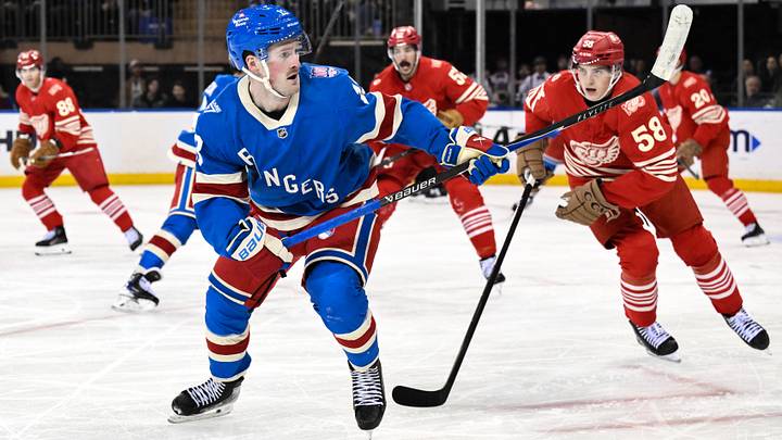 Nov 16, 2025; New York, New York, USA; New York Rangers left wing Alexis Lafrenière (13) skates past Detroit Red Wings center Emmitt Finnie (58) during the third period at Madison Square Garden. Mandatory Credit: John Jones-Imagn Images