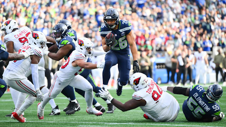 Nov 9, 2025; Seattle, Washington, USA; Seattle Seahawks running back Zach Charbonnet (26) rushes for a touchdown during the second quarter against the Arizona Cardinals at Lumen Field.