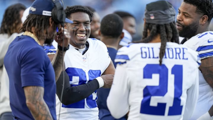 Dallas Cowboys cornerback DaRon Bland (26) smiles with teammates defensive tackle Johnathan Hankins (95) and former cornerback Stephon Gilmore (21) as the final seconds tick away against the Carolina Panthers during the second half at Bank of America Stadium.