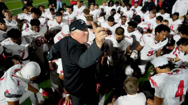 Midwest City Carl Albert coach Mike Dunn talks to his players after the Titans won a state-record 59th consecutive game, beating Noble 41-6 on Oct. 2, 2026.