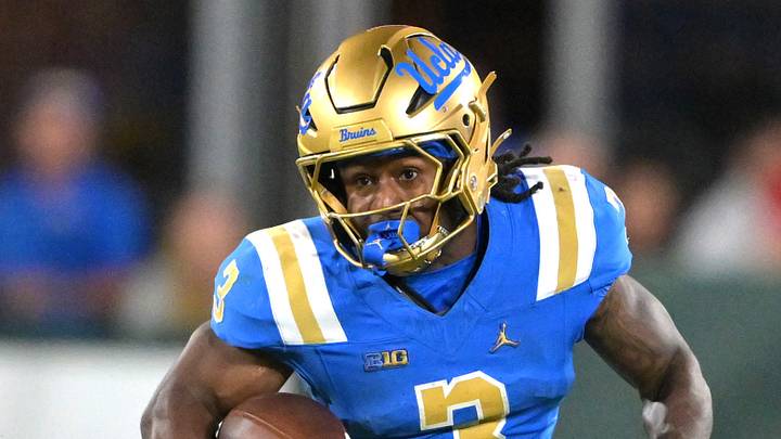 Oct 17, 2026; Pasadena, California, USA;  UCLA Bruins running back Wayne Knight (3) runs for a first down before he is stopped by Wisconsin Badgers cornerback Bryce West (5) in the second half at the Rose Bowl. Mandatory Credit: Jayne Kamin-Oncea-Imagn Images