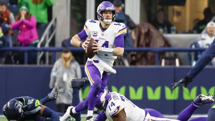 Dec 22, 2024; Seattle, Washington, USA; Minnesota Vikings quarterback Sam Darnold (14) scrambles out of the pocket against the Seattle Seahawks during the fourth quarter at Lumen Field.