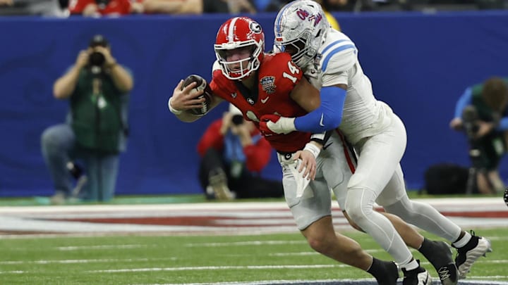 Jan 1, 2026; New Orleans, LA, USA; Mississippi Rebels linebacker Suntarine Perkins (4) sacks Georgia Bulldogs quarterback Gunner Stockton (14) on a fourth down conversion attempt in the fourth quarter during the 2026 Sugar Bowl and quarterfinal game of the College Football Playoff at Caesars Superdome. Mandatory Credit: Geoff Burke-Imagn Images