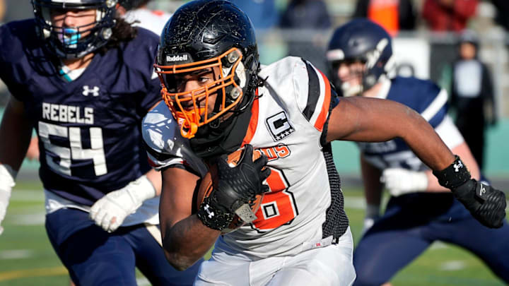 West Warwick captain, running back James Branch IV runs for Wizard yardage during a first half run.
