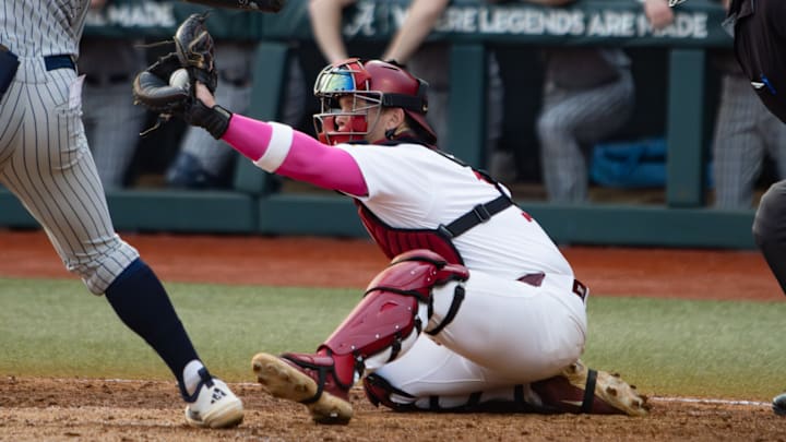 Alabama catcher Brady Neal catches the ball in the first game of the series against Rhode Island on Feb. 20, 2026. Alabama catcher Brady Neal catches the ball in the first game of the series against Rhode Island on Feb. 20, 2026.