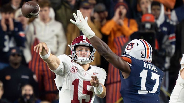 Alabama quarterback Ty Simpson (15) throws under pressure form Auburn linebacker Xavier Atkins (17) Alabama quarterback Ty Simpson (15) throws under pressure form Auburn linebacker Xavier Atkins (17)