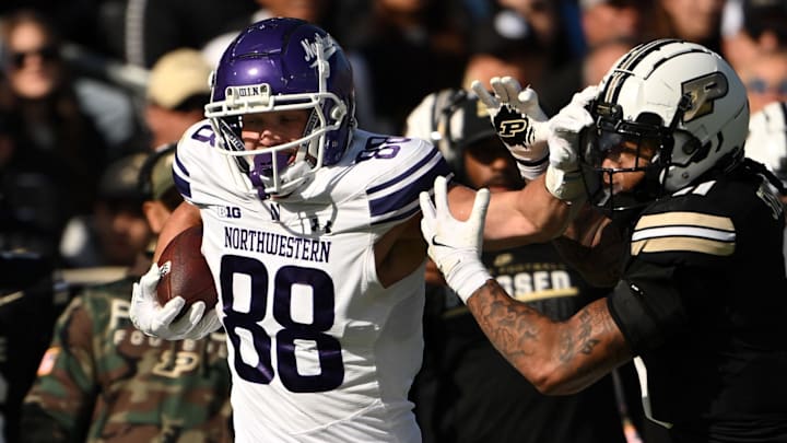 Nov 2, 2024; West Lafayette, Indiana, USA; Northwestern Wildcats tight end Marshall Lang (88) pushes away Purdue Boilermakers defensive back Antonio Stevens (11) during the second quarter at Ross-Ade Stadium.