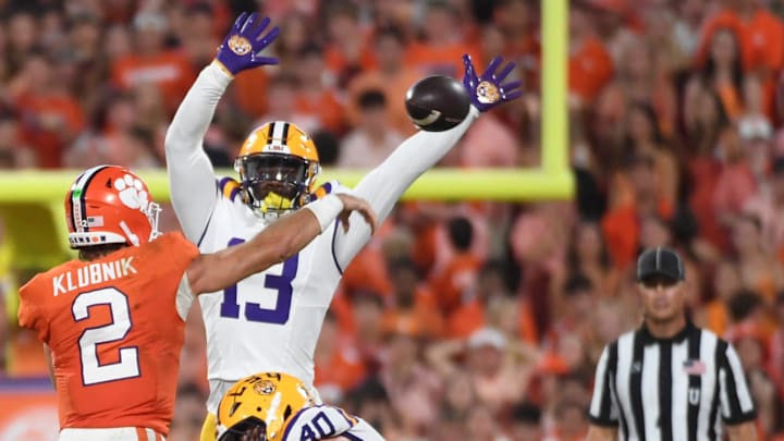 LSU Tigers linebacker Whit Weeks (40) and LSU Tigers safety A.J. Haulcy (13) rush Clemson Tigers quarterback Cade Klubnik (2) Saturday, Aug. 30, 2025 during the NCAA football game at Memorial Stadium in Clemson, South Carolina. LSU Tigers won 17-10.