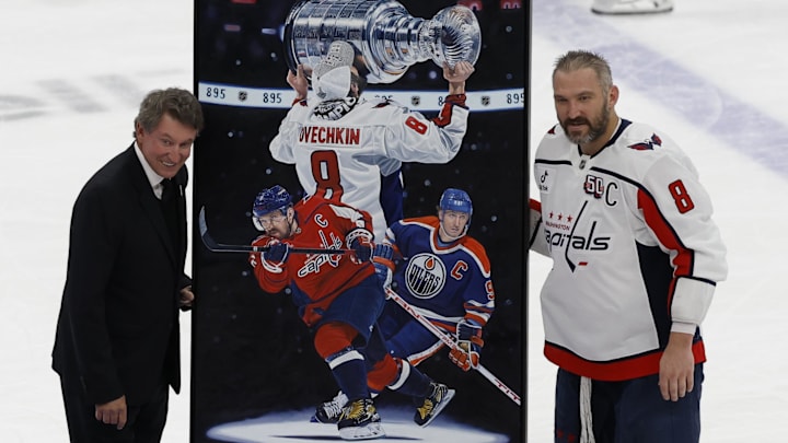 Apr 6, 2025; Elmont, New York, USA;  Washington Capitals left wing Alex Ovechkin (8) is honored with a painting by artist Tony Harris by former Canadian-American ice hockey player Wayne Gretzky after scoring in the during the second period against the New York Islanders at UBS Arena. Ovechkin scored the 895th goal of his career, breaking the NHL all-time career goals record previously held by Wayne Gretzky at UBS Arena. Mandatory Credit: Geoff Burke-Imagn Images
