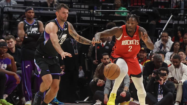 Feb 23, 2026; Houston, Texas, USA;  Utah Jazz guard John Konchar (55) and Houston Rockets forward Dorian Finney-Smith (2) reach for a loose ball in the fourth quarter at Toyota Center. Mandatory Credit: Thomas Shea-Imagn Images