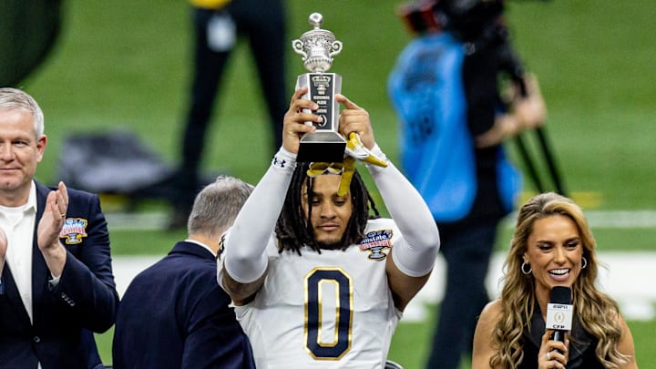 Jan 2, 2025; New Orleans, LA, USA;  Notre Dame Fighting Irish safety Xavier Watts (0) holds up the Sugar Bowl outstanding defensive player trophy after the game against the Georgia Bulldogs at Caesars Superdome. Mandatory Credit: Stephen Lew-Imagn Images