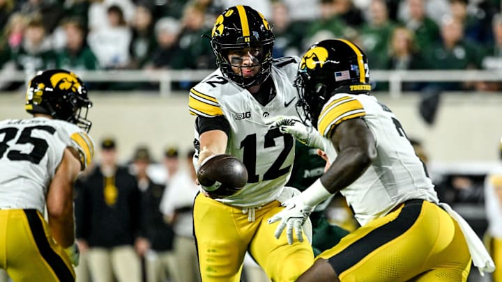 Iowa's Cade McNamara, left, hands off to Kaleb Johnson during the first quarter in the game against Michigan State on Saturday, Oct. 19, 2024, at Spartan Stadium in East Lansing.