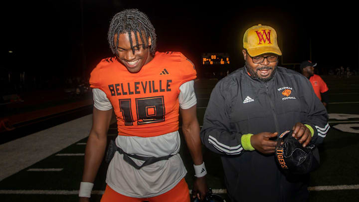 Belleville quarterback Bryce Underwood (19) walks next to one of his coaches, LeeAndrew Omorogieva, at the end of a 35-8 victory against Westland Glenn in Belleville on Friday, Sept. 29, 2023. Belleville quarterback Bryce Underwood (19) walks next to one of his coaches, LeeAndrew Omorogieva, at the end of a 35-8 victory against Westland Glenn in Belleville on Friday, Sept. 29, 2023.
