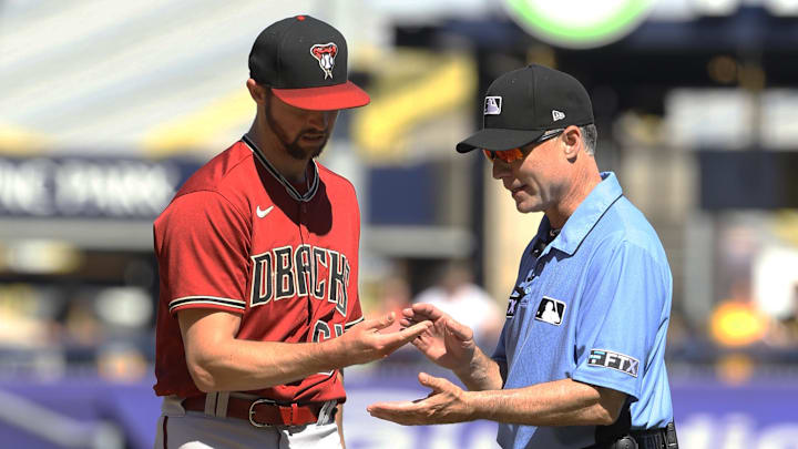 Arizona Diamondbacks relief pitcher Sean Poppen (64) has his fingers checked by second base umpire Dan Iassogna against the Pittsburgh Pirates during the eighth inning at PNC Park.