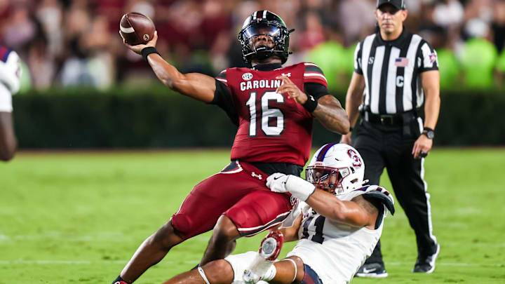 Sep 6, 2025; Columbia, South Carolina, USA; South Carolina Gamecocks quarterback LaNorris Sellers (16) passes as he is brought down by South Carolina State Bulldogs defensive end Mike Lunz (11) in the second quarter at Williams-Brice Stadium. Mandatory Credit: Jeff Blake-Imagn Images