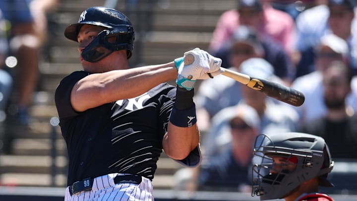 Mar 18, 2025; Tampa, Florida, USA; New York Yankees outfielder Aaron Judge (99) doubles against the Boston Red Sox in the fourth inning during spring training at George M. Steinbrenner Field. 