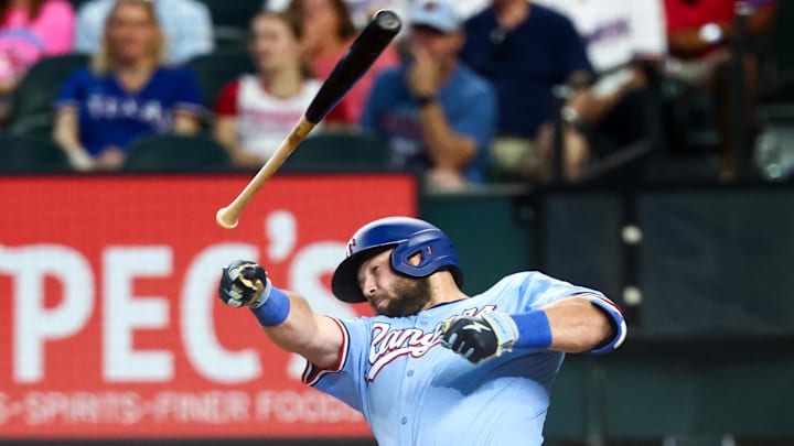 Aug 10, 2025; Arlington, Texas, USA;  Texas Rangers first baseman Jake Burger (21) loses his bat during the sixth inning against the Philadelphia Phillies at Globe Life Field.