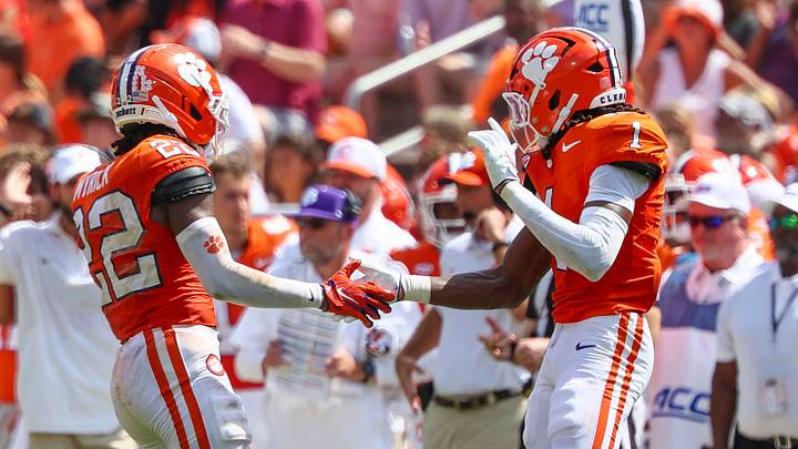 Sep 19, 2026; Clemson, South Carolina, USA; Clemson Tigers corner back Ashton Hampton (2) and cornerback Branden Strozier (1) celebrate a tackle during the third quarter against University of North Carolina Tar Heels at Memorial Stadium. Mandatory Credit: Ashley Tumlin-Imagn Images Sep 19, 2026; Clemson, South Carolina, USA; Clemson Tigers corner back Ashton Hampton (2) and cornerback Branden Strozier (1) celebrate a tackle during the third quarter against University of North Carolina Tar Heels at Memorial Stadium. Mandatory Credit: Ashley Tumlin-Imagn Images