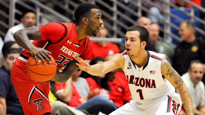 Dec 3, 2013; Tucson, AZ, USA; Texas Tech Red Raiders guard Jamal Williams Jr. (23) prepares to pass as he is defended by Arizona Wildcats guard Gabe York (1) during the second half at McKale Center. Arizona defeated Texas Tech 79-58. Mandatory Credit: Casey Sapio-Imagn Images