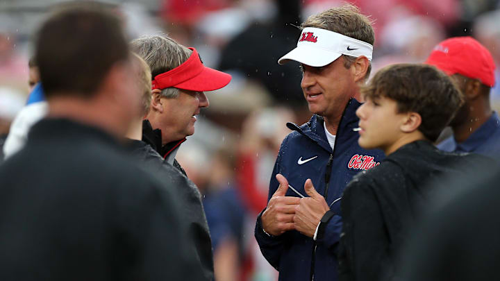 Nov 9, 2024; Oxford, Mississippi, USA; Georgia Bulldogs head coach Kirby Smart and Mississippi Rebels head coach Lane Kiffin talk prior to the game at Vaught-Hemingway Stadium. Mandatory Credit: Petre Thomas-Imagn Images