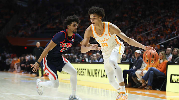 Feb 3, 2026; Knoxville, Tennessee, USA;  Tennessee Volunteers forward Nate Ament (10) moves the ball against Mississippi Rebels guard Patton Pinkins (23) during the first half at Thompson-Boling Arena at Food City Center. Mandatory Credit: Randy Sartin-Imagn Images