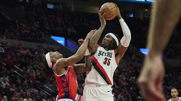 Jan 16, 2025; Portland, Oregon, USA; Portland Trail Blazers center Robert Williams III (35) grabs a rebound during the second half against LA Clippers guard Terance Mann (14) at Moda Center. Mandatory Credit: Troy Wayrynen-Imagn Images