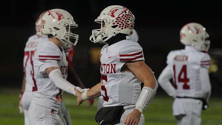 Newton Cardinals quarterback/defensive back Caden Klein (5) gets congratulation by team mates after winning against Gilbert in the high school football class 4A quarterfinal on Nov. 7, 2025, at Tigers Stadium, Gilbert, Iowa.