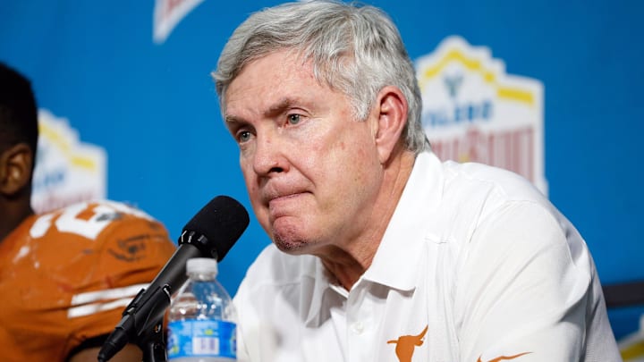Dec 30, 2013; San Antonio, TX, USA; Texas Longhorns head coach Mack Brown reacts during the post game press conference after a game against the Oregon Ducks at Alamo Dome. Oregon defeated Texas 30-7. Mandatory Credit: Soobum Im-Imagn Images Dec 30, 2013; San Antonio, TX, USA; Texas Longhorns head coach Mack Brown reacts during the post game press conference after a game against the Oregon Ducks at Alamo Dome. Oregon defeated Texas 30-7. Mandatory Credit: Soobum Im-Imagn Images