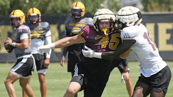 Arizona State tight end James Giggey (45), left, and defensive back Adama Fall battle during football practice at Kajikawa practice fields in Tempe on Aug 1, 2025.
