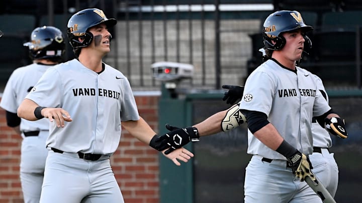 Vanderbilt’s Riley Nelson, left, is congratulated after scoring on a bases loaded double by Colin Barczi in the first inning of an NCAA college baseball game against Tennessee Tech at Hawkins Field Tuesday, Feb. 25, 2025, in Nashville, Tenn.