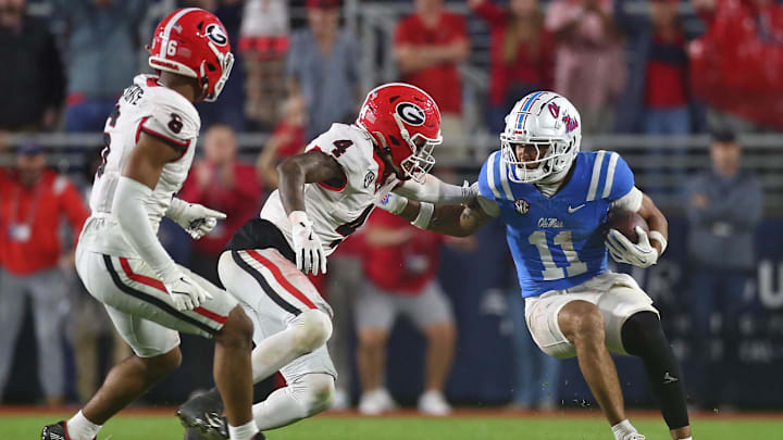 Nov 9, 2024; Oxford, Mississippi, USA; Mississippi Rebels wide receiver Jordan Watkins (11) runs after a catch as Georgia Bulldogs defensive back KJ Bolden (4) attempts to make the tackle during the second half  at Vaught-Hemingway Stadium. Mandatory Credit: Petre Thomas-Imagn Images