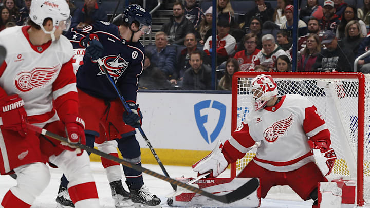 Jan 2, 2025; Columbus, Ohio, USA; Columbus Blue Jackets left wing Dmitri Voronkov (10) tips a puck on goal against the Detroit Red Wings during the first period at Nationwide Arena. Mandatory Credit: Russell LaBounty-Imagn Images