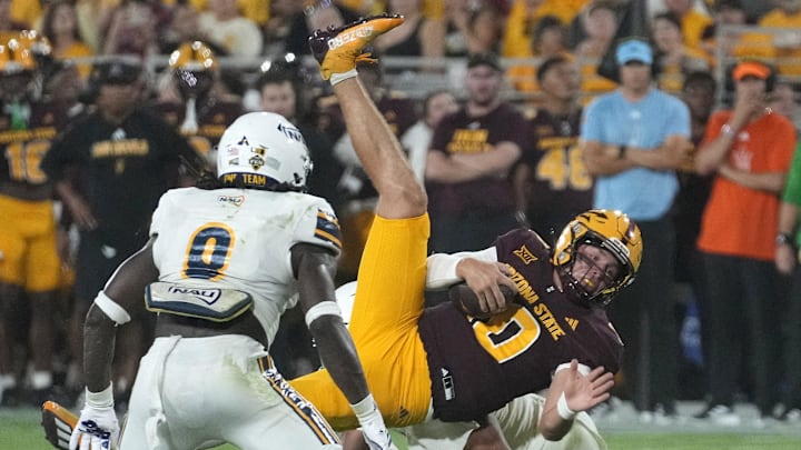 Arizona State Sun Devils quarterback Sam Leavitt (10) is tackled by Northern Arizona Lumberjacks defense during a football game at Mountain America Stadium in Tempe on Aug. 30, 2025.