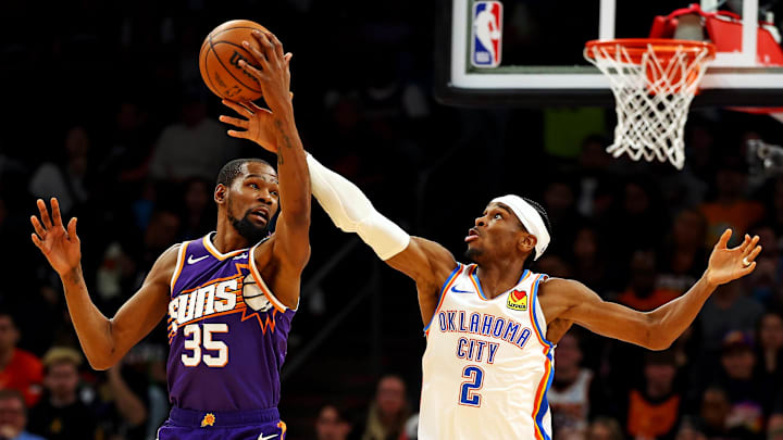 Mar 3, 2024; Phoenix, Arizona, USA; Phoenix Suns forward Kevin Durant (35) and Oklahoma City Thunder guard Shai Gilgeous-Alexander (2) go for the ball during the second quarter at Footprint Center. Mandatory Credit: Mark J. Rebilas-Imagn Images