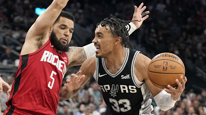 Mar 12, 2024; San Antonio, Texas, USA; San Antonio Spurs guard Tre Jones (33) drives to the basket while defended by Houston Rockets guard Fred VanVleet (5) during the second half at Frost Bank Center.