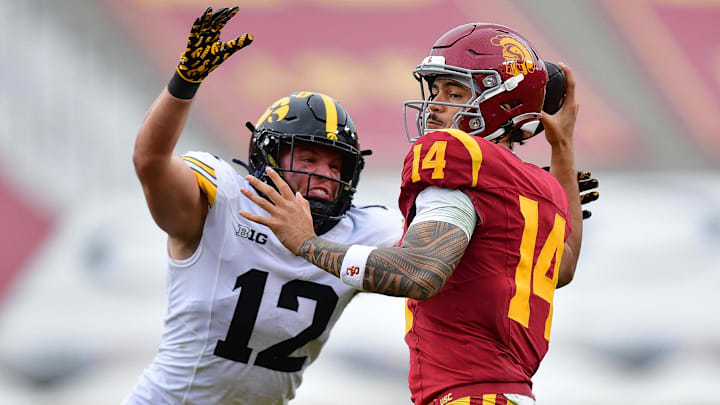 Nov 15, 2025; Los Angeles, California, USA; Iowa Hawkeyes defensive back Jaxon Rexroth (12) moves in against Southern California Trojans quarterback Jayden Maiava (14) during the second half at the Los Angeles Memorial Coliseum. Mandatory Credit: Gary A. Vasquez-Imagn Images