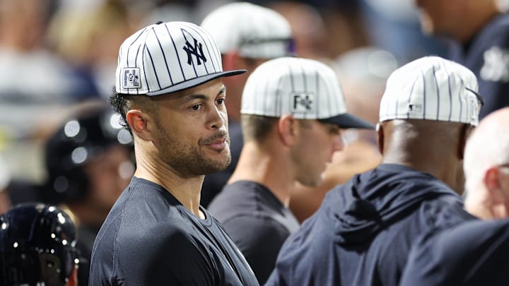 Mar 14, 2025; Tampa, Florida, USA; New York Yankees designated hitter Giancarlo Stanton (27) looks on from the dugout against the Philadelphia Phillies in the sixth inning during spring training at George M. Steinbrenner Field. Mandatory Credit: Nathan Ray Seebeck-Imagn Images