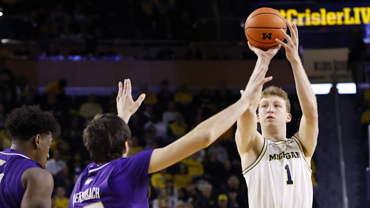 Jan 12, 2025; Ann Arbor, Michigan, USA; Michigan Wolverines center Danny Wolf (1) shoots on Washington Huskies forward Wilhelm Breidenbach (32) in the first half at Crisler Center. Mandatory Credit: Rick Osentoski-Imagn Images