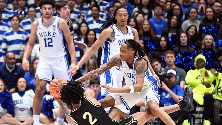 Jan 24, 2026; Durham, North Carolina, USA; Wake Forest Demon Deacons guard Juke Harris (2) throws a pass while falling as Duke Blue Devils forward Isaiah Evans (3) defends during the second half at Cameron Indoor Stadium. Mandatory Credit: Rob Kinnan-Imagn Images