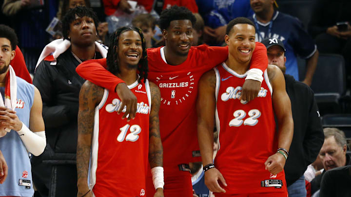 Dec 19, 2024; Memphis, Tennessee, USA; Memphis Grizzlies guard Ja Morant (left), forward Jaren Jackson Jr. (middle) and guard Desmond Bane (right) react during the fourth quarter against the Golden State Warriors at FedExForum. Mandatory Credit: Petre Thomas-Imagn Images
