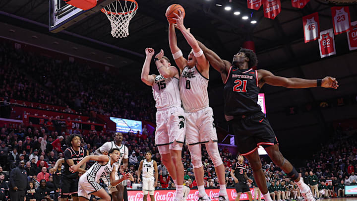 Jan 27, 2026; Piscataway, New Jersey, USA; Michigan State Spartans forward Jaxon Kohler (0) rebounds against Rutgers Scarlet Knights center Emmanuel Ogbole (21) during the second half at Jersey Mike's Arena. Mandatory Credit: Vincent Carchietta-Imagn Images