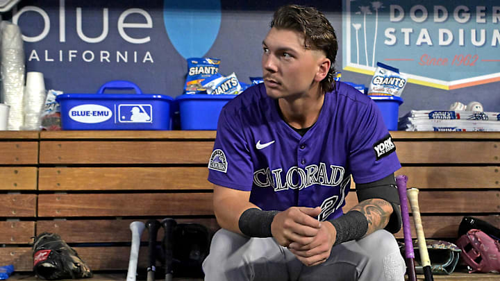 Colorado Rockies Jordan Beck (27) waits in the dugout before the game against the Los Angeles Dodgers at Dodger Stadium. 