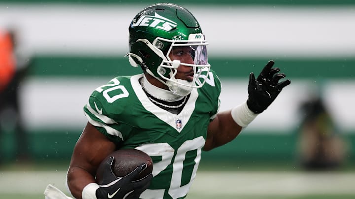 Nov 30, 2025; East Rutherford, New Jersey, USA; New York Jets running back Breece Hall (20) rushes the ball against the Atlanta Falcons during the first half at MetLife Stadium. 
