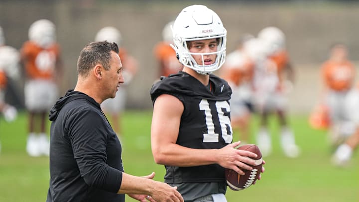 Texas head coach Steve Sarkisian talks to quarterback Arch Manning during the first football practice of 2023.