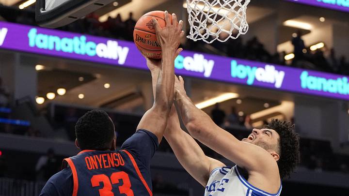 Mar 14, 2026; Charlotte, NC, USA; Duke Blue Devils forward Cameron Boozer (12) with the ball as Virginia Cavaliers center Ugonna Onyenso (33) defends in the second half during the men's ACC Conference Tournament Championship at Spectrum Center. Mandatory Credit: Bob Donnan-Imagn Images